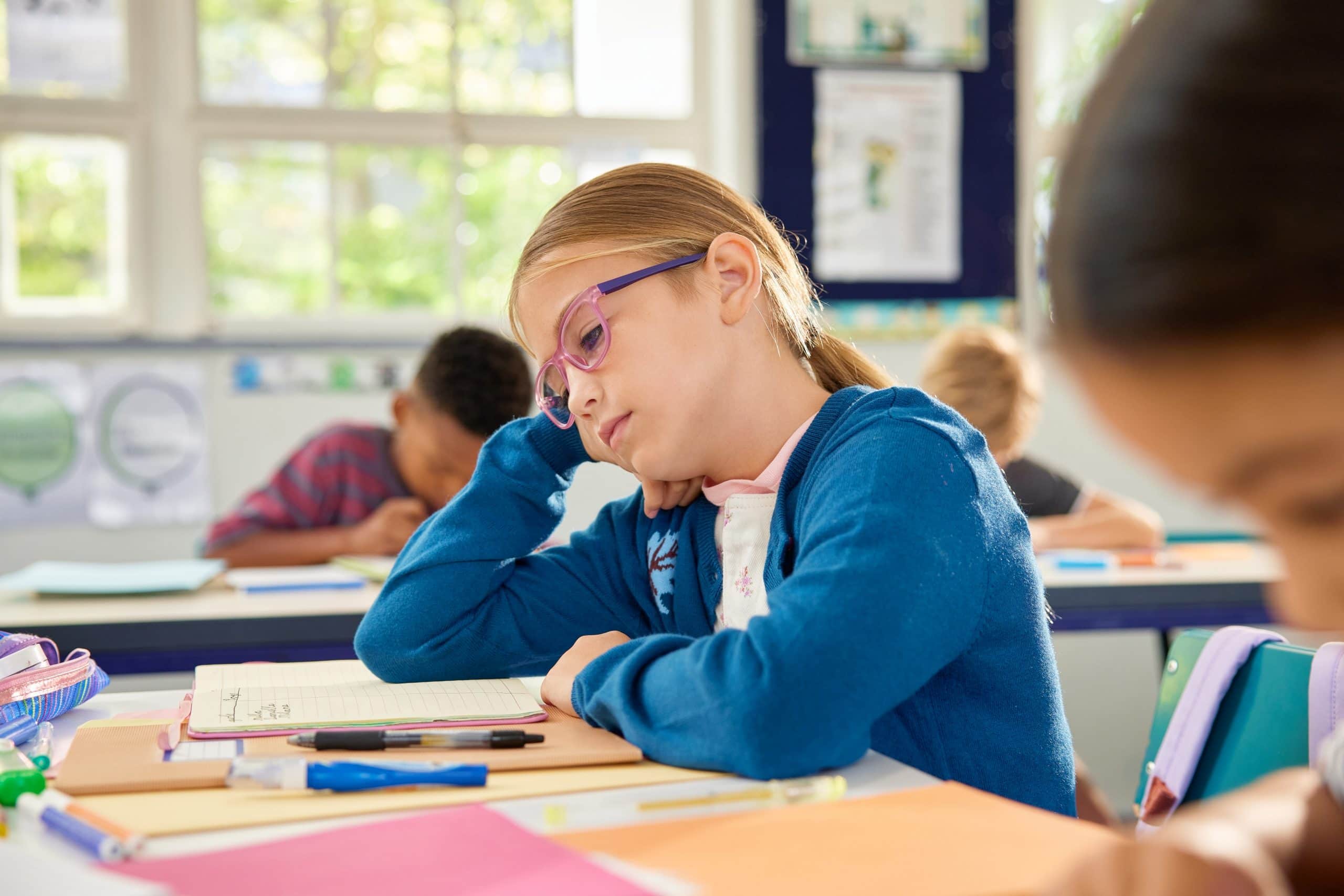Bored school girl in classroom at school